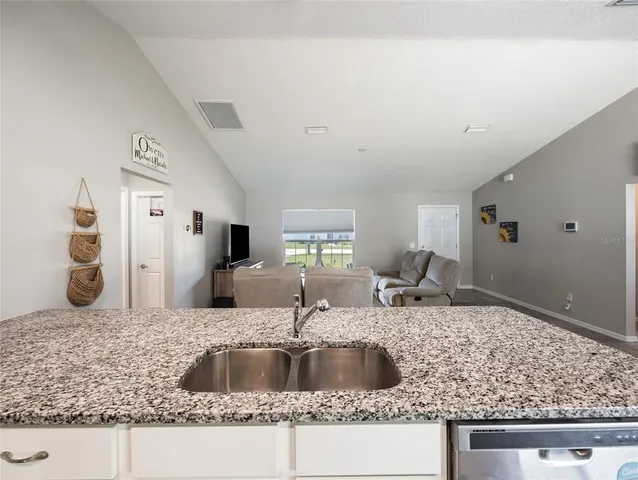 a kitchen with a sink and a refrigerator
