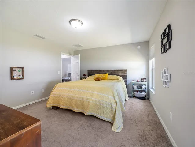 a bedroom with a bed and cabinets