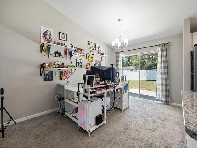 a view of living room with furniture and a chandelier