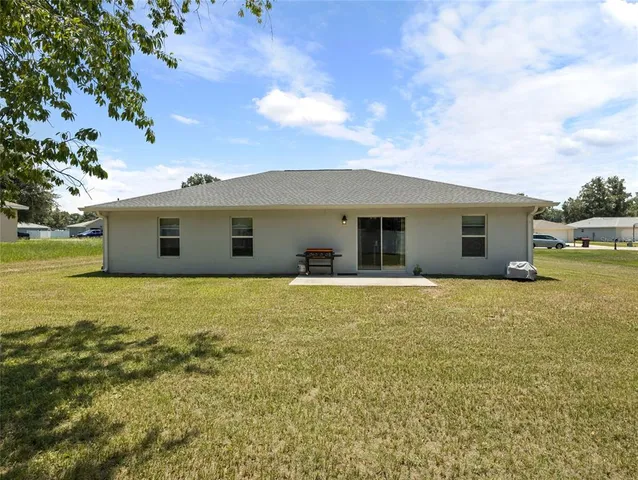 a view of a house with backyard porch and garden