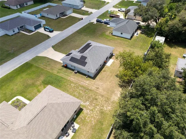an aerial view of a house with swimming pool and ocean view