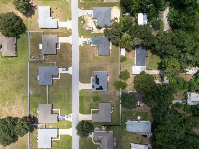 aerial view of a house with outdoor space and street view