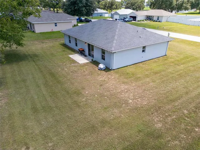 a aerial view of residential houses with outdoor space and swimming pool