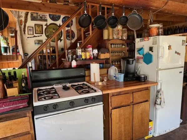 a kitchen with stainless steel appliances granite countertop a stove and a sink