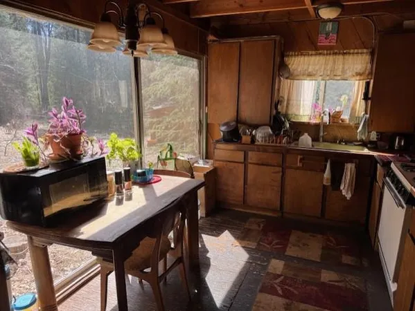 a kitchen with a table chairs and a stove