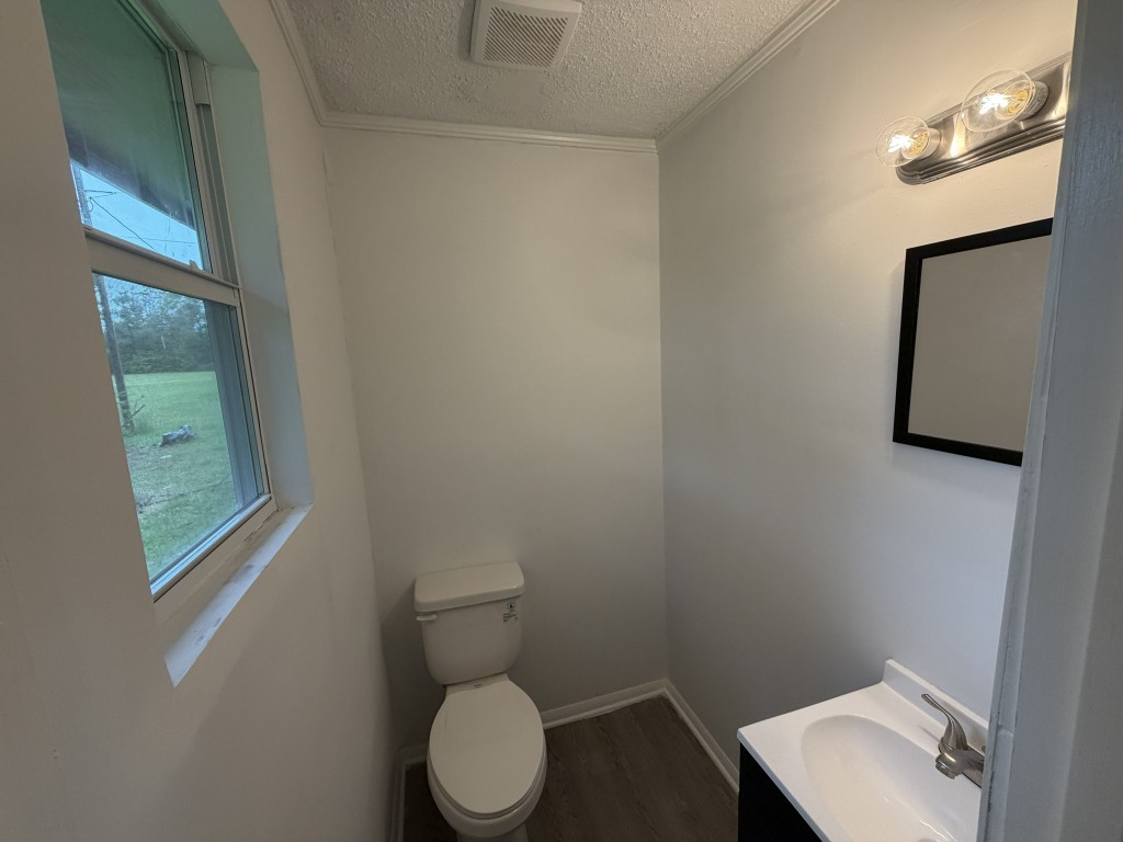 920 Damron Loop Counce, TN 38326 - Photo 12 of 14 a white toilet sitting next to a bathroom sink