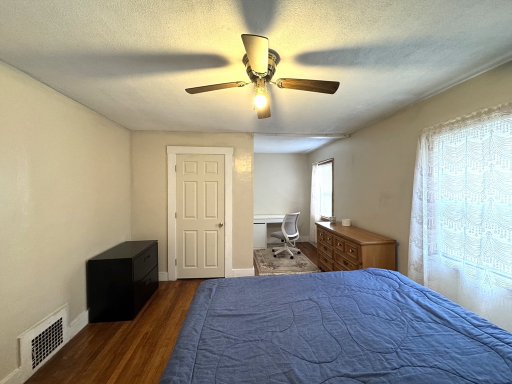 30 Thorpe Street, Unit 2 Somerville, MA 02143 - Photo 4 of 9 a bedroom with a bed and wooden floor