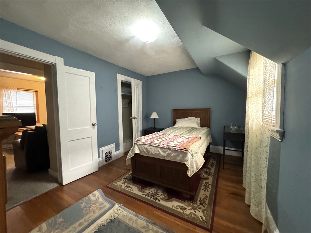 30 Thorpe Street, Unit 2 Somerville, MA 02143 - Photo 5 of 9 a bedroom with a bed and wooden floor