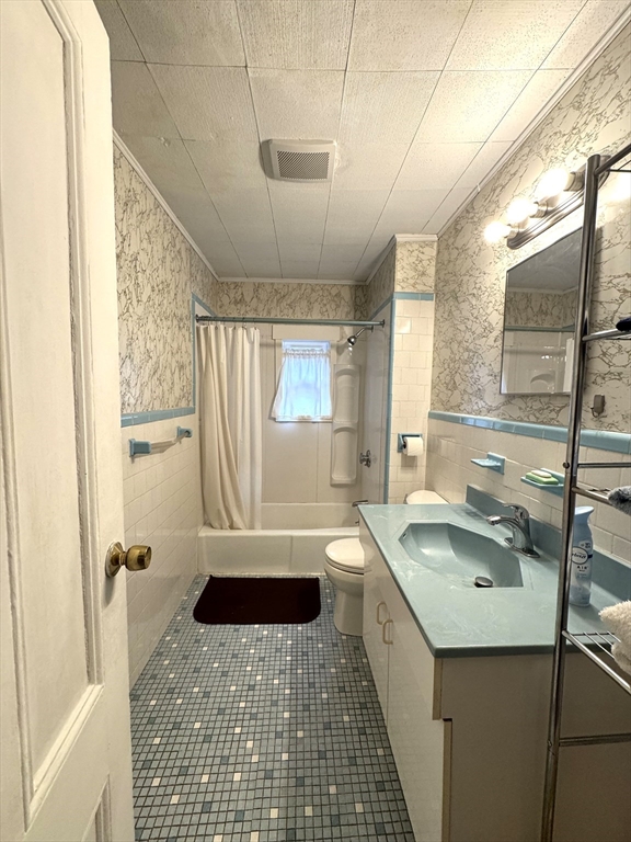 30 Thorpe Street, Unit 2 Somerville, MA 02143 - Photo 7 of 9 a bathroom with a sink a toilet and tub