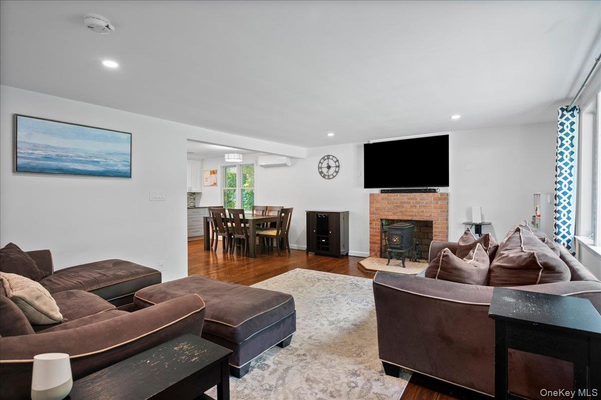105 High St Extension Mount Kisco, NY 10549 - Photo 12 of 38 a living room with furniture a fireplace and a flat screen tv