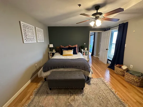 a spacious bedroom with a bed and a chandelier