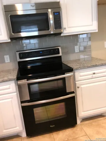 a bedroom with a bed chair and a window