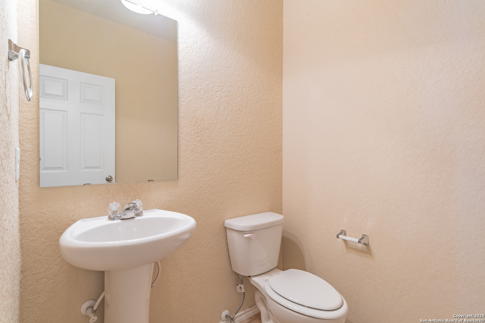 7710 Paraiso Haven Boerne, TX 78015 - Photo 17 of 29 a bathroom with a sink a toilet and a mirror