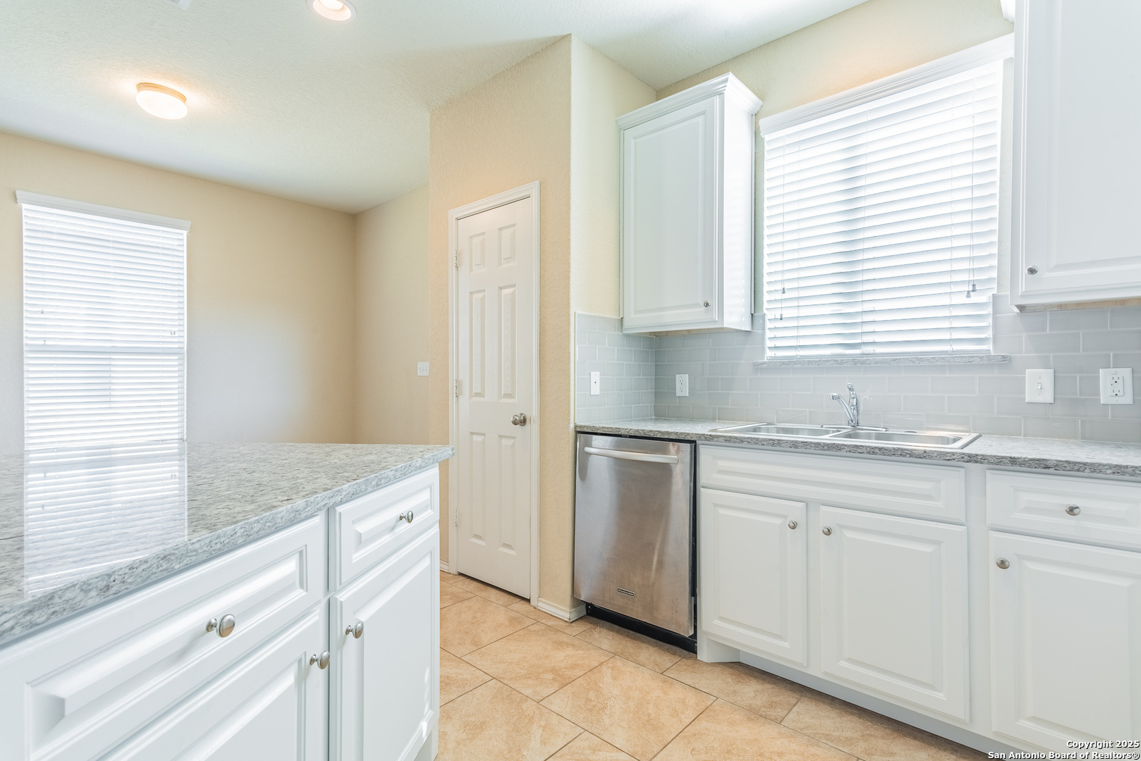 7710 Paraiso Haven Boerne, TX 78015 - Photo 10 of 29 a kitchen with granite countertop white cabinets and a sink