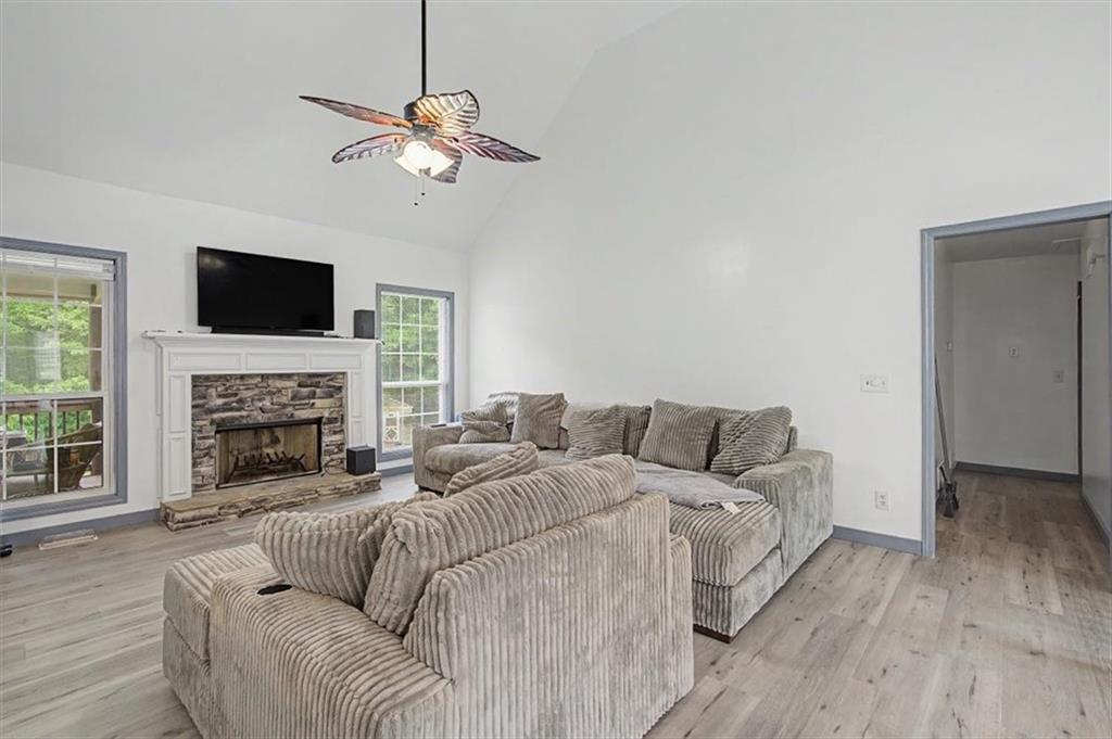 409 Windsor Way Canton, GA 30115 - Photo 6 of 51 a living room with furniture a fireplace and a flat screen tv