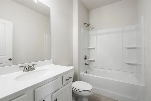 a bathroom with a sink toilet vanity and shower