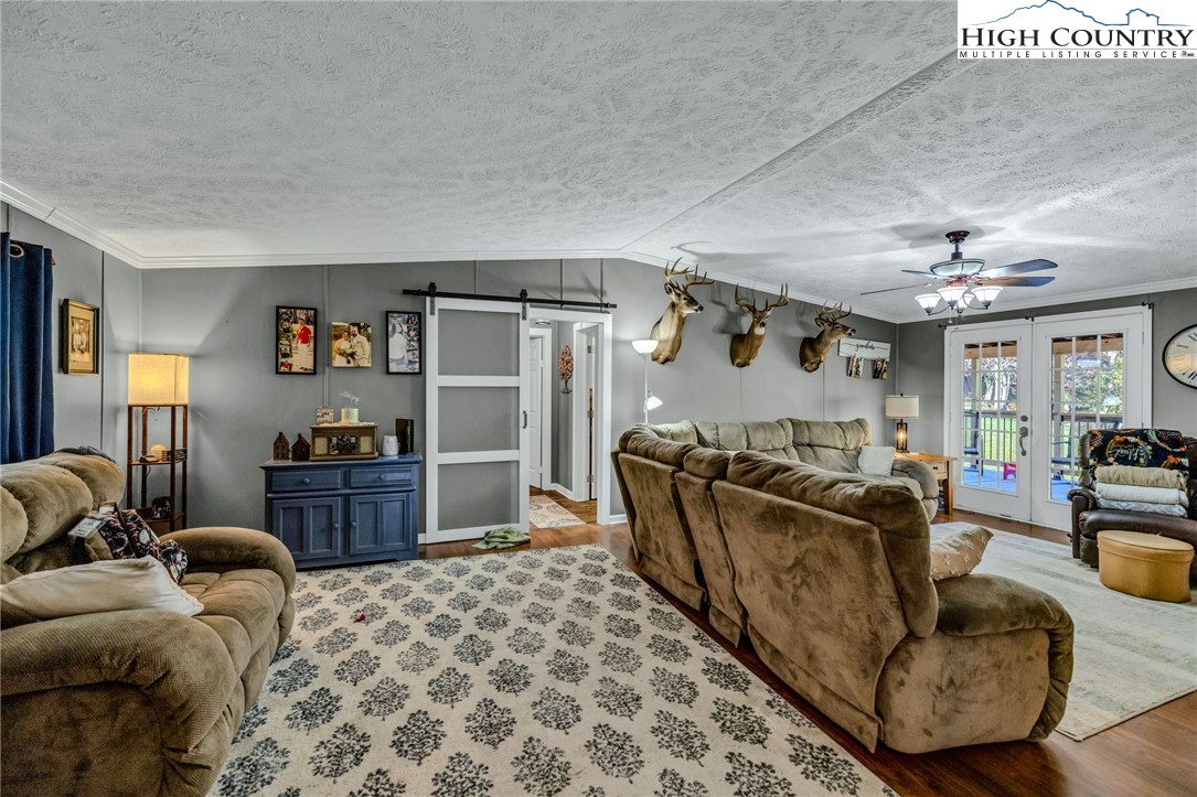 1108 Bald Knob Road Sparta, NC 28675 - Photo 21 of 43 a living room with furniture and a chandelier