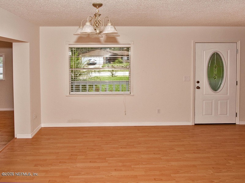 221 Swallow Road St. Augustine, FL 32086 - Photo 3 of 17 a view of an empty room with window and wooden floor