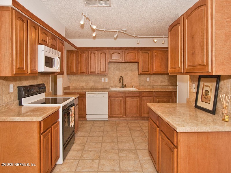 221 Swallow Road St. Augustine, FL 32086 - Photo 4 of 17 a kitchen with a sink stove and cabinets