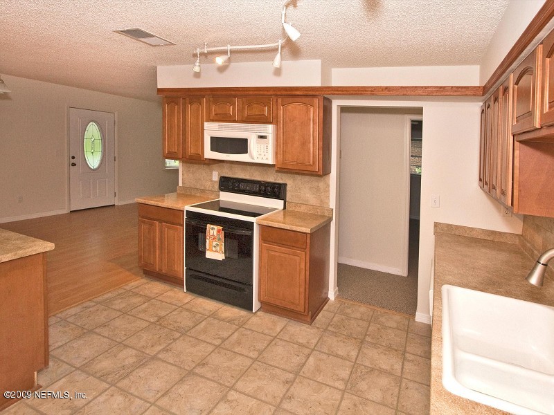 221 Swallow Road St. Augustine, FL 32086 - Photo 5 of 17 a kitchen with stainless steel appliances granite countertop a stove a sink and a refrigerator