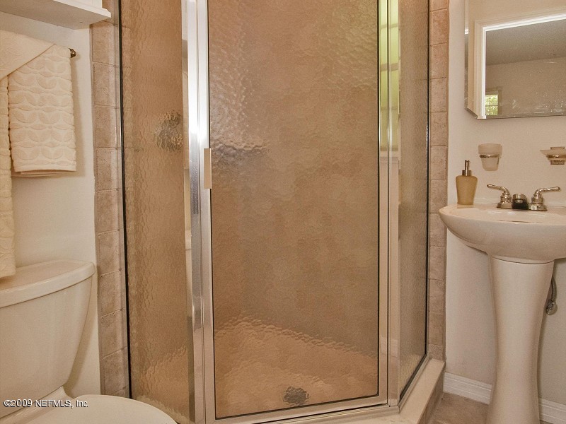 221 Swallow Road St. Augustine, FL 32086 - Photo 7 of 17 a bathroom with a sink mirror and toilet