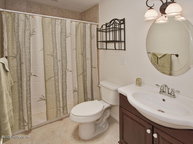221 Swallow Road St. Augustine, FL 32086 - Photo 9 of 17 a bathroom with a toilet a sink and shower