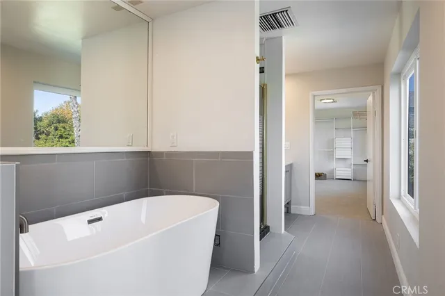 a bathroom with a tub and shower