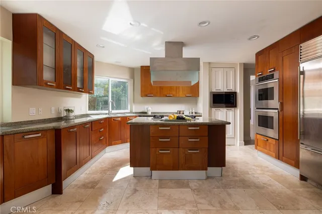 a large kitchen with stainless steel appliances and cabinets