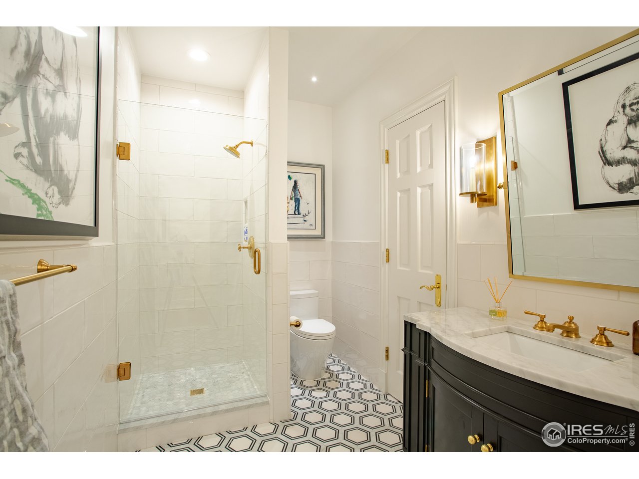 985 Gilbert Street Boulder, CO 80302 - Photo 30 of 40 a bathroom with a granite countertop sink a toilet a shower and a mirror