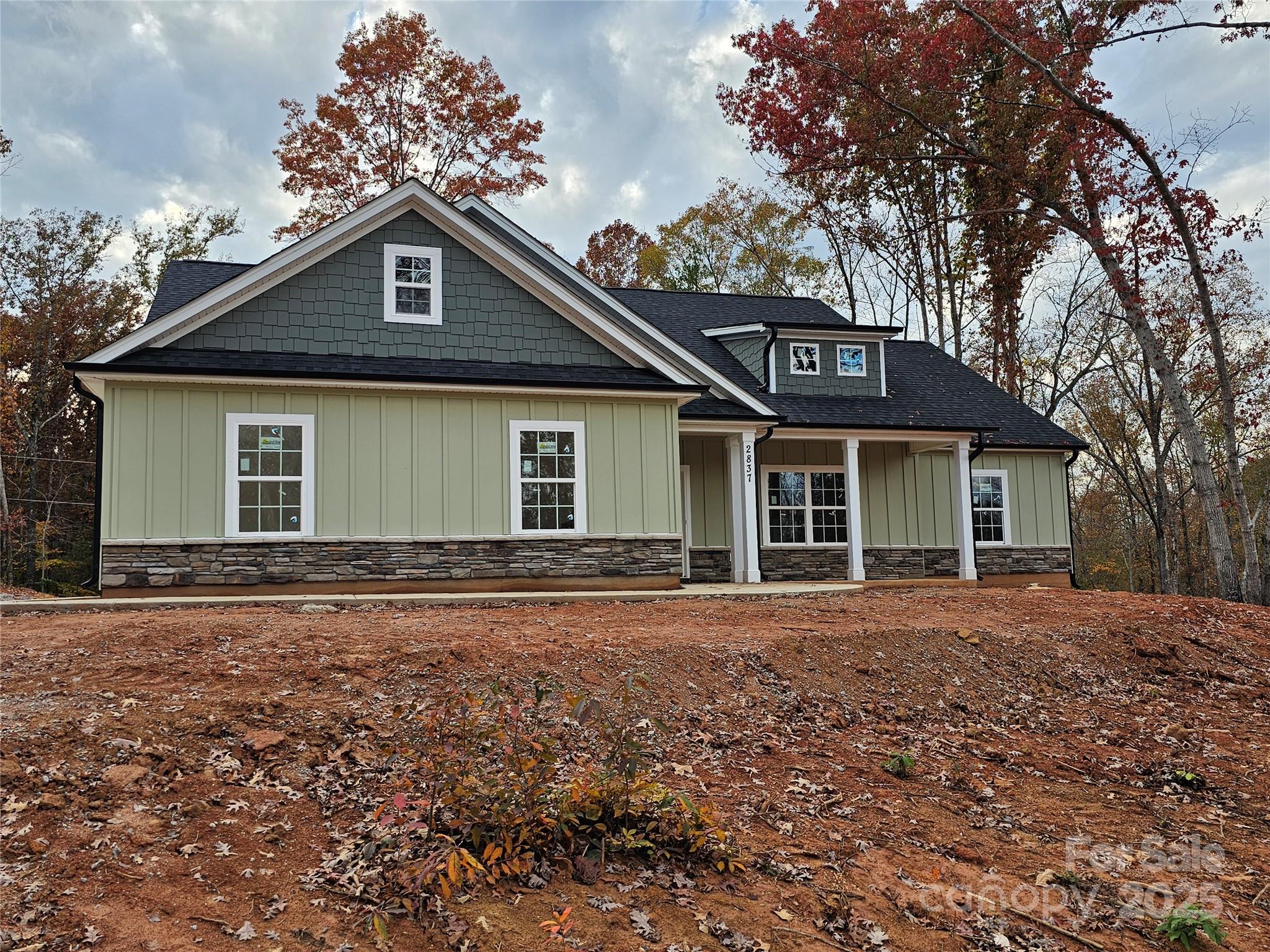 a front view of a house with a garden