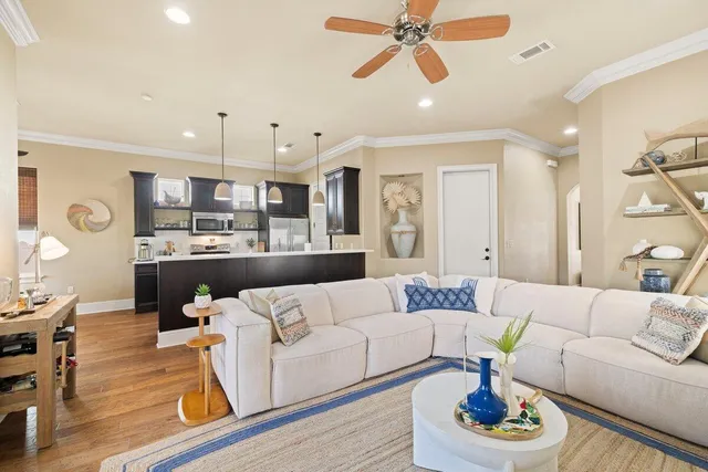 a living room with furniture kitchen and a chandelier
