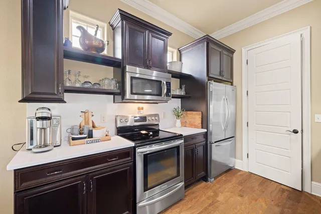 a kitchen with stainless steel appliances a stove microwave and cabinets