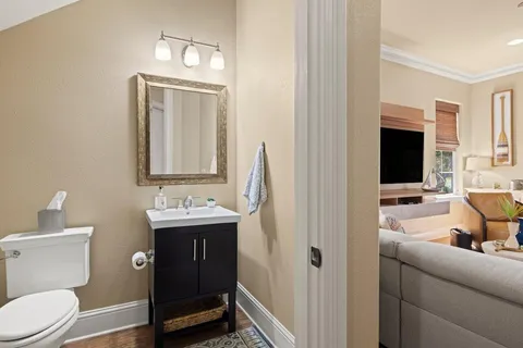 a bathroom with a toilet sink and mirror