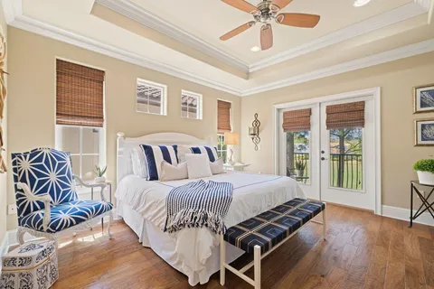a bedroom with a bed and glass walk in closet