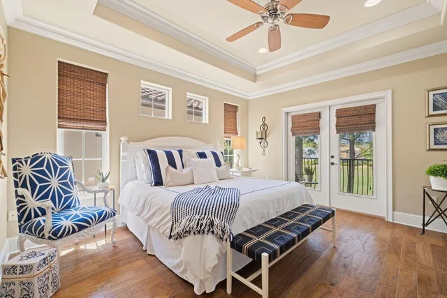 a bedroom with a bed and glass walk in closet