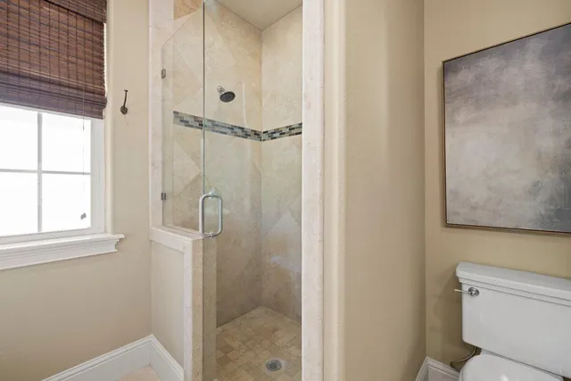 a bathroom with a shower and toilet