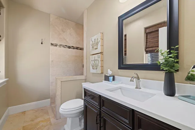 a bathroom with a sink a toilet and mirror