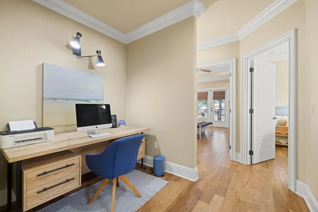 a view of a workspace with furniture and wooden floor