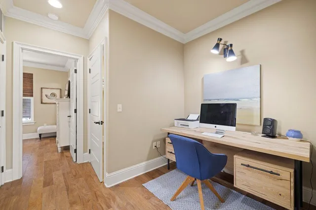 a view of a workspace with furniture and wooden floor