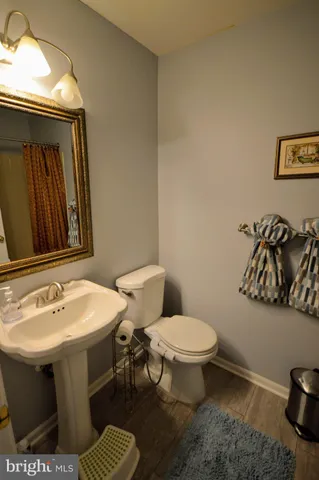 a bathroom with a sink toilet and mirror