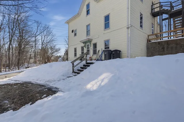 a view of a house with a snow in the yard