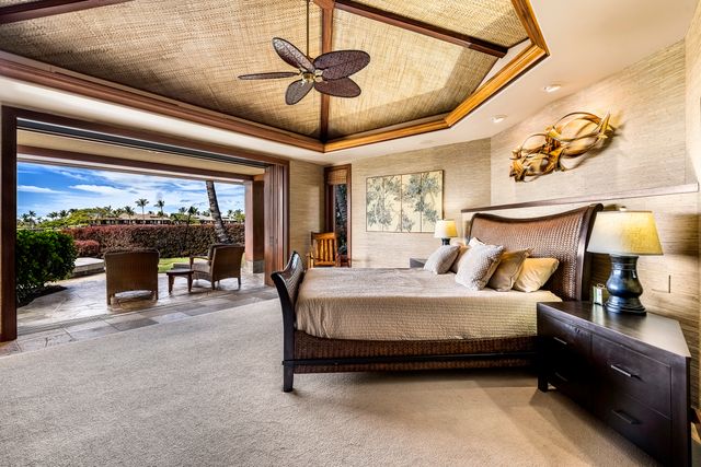 a bed room with a bed and a chandelier