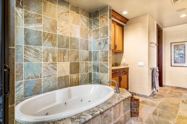 a bathroom with a tub and a sink