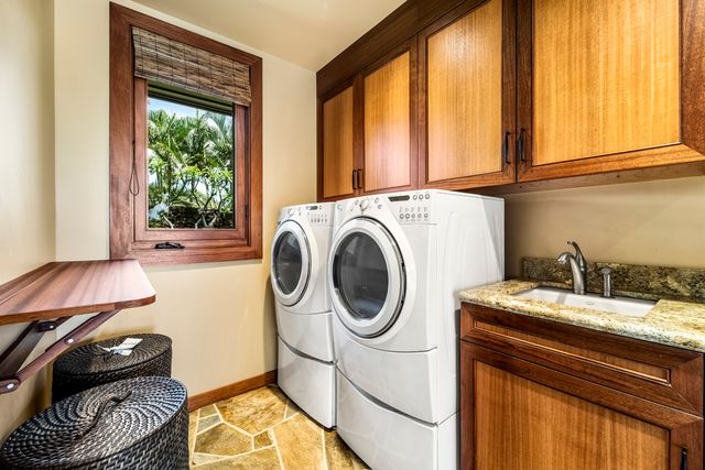 a utility room with sink dryer and washer