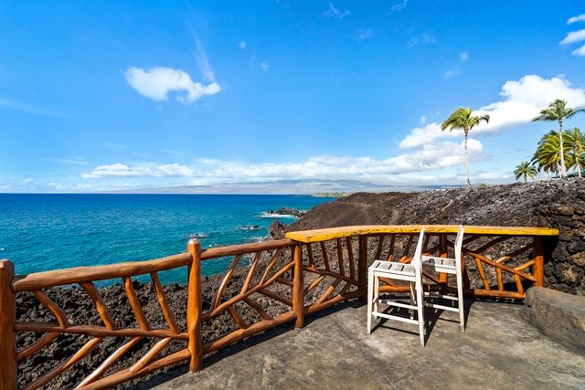 a view of a roof deck with furniture