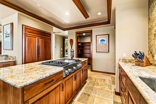a kitchen that has a stove and a refrigerator