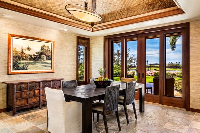 a view of a dining room with furniture large windows and wooden floor