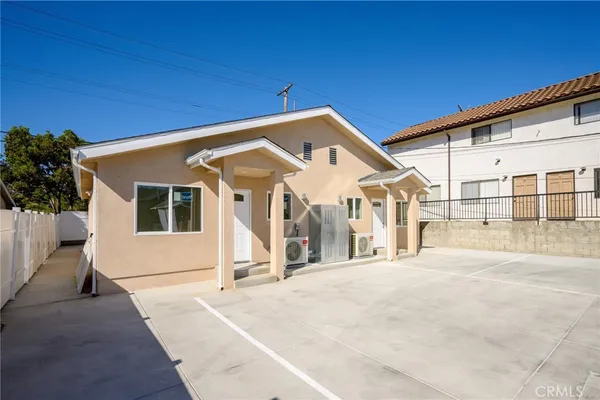 a view of a house with a wooden fence