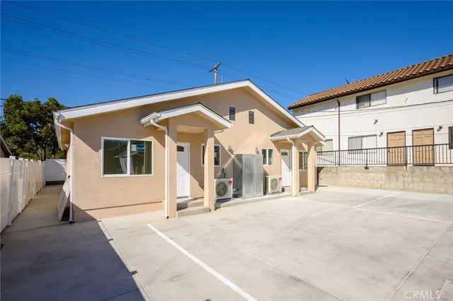 a view of a house with a wooden fence