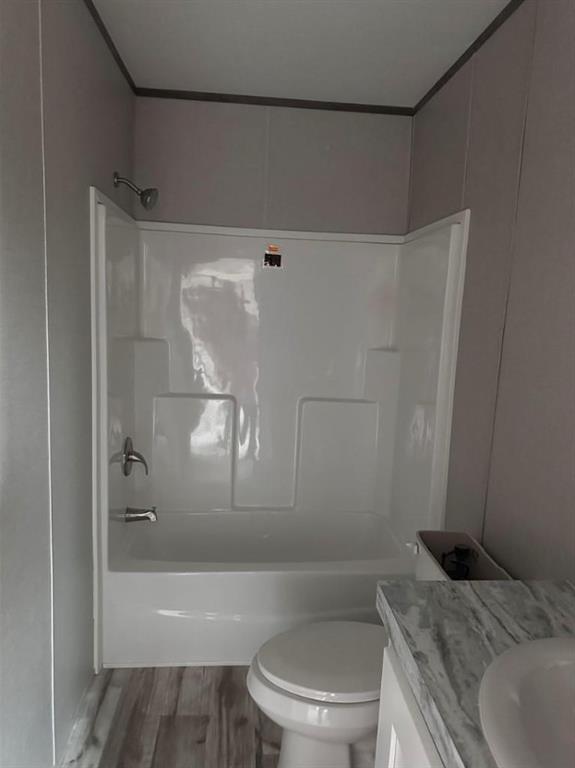 1848 South 4th Merkel, TX 79536 - Photo 7 of 8 a bathroom with a granite countertop bathtub shower sink vanity and toilet